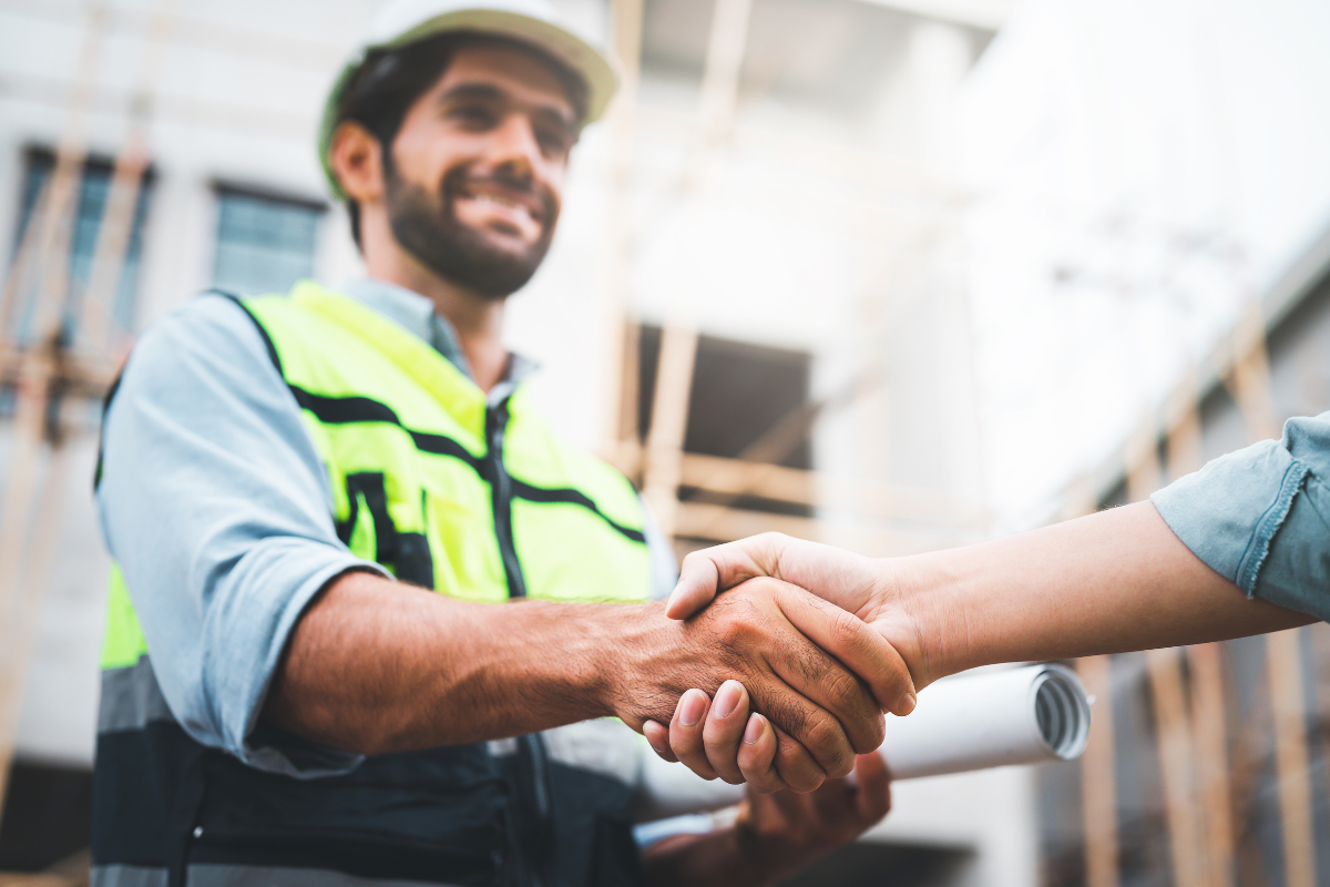 trade business owner shaking hands after winning a tender