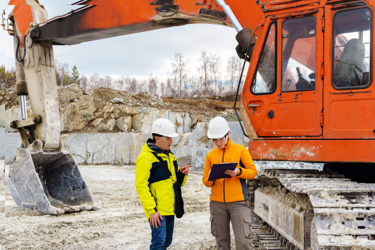 construction site with two tradies looking at paper work standing next to a truck