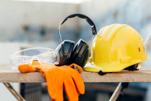 hard hat, gloves and noise proof headphones for a tradie on a construction site
