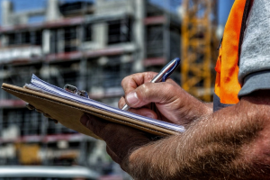 compliance officer checking paperwork on a construction site
