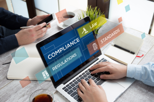 construction business admins sitting at a laptop sorting their crews compliance documents