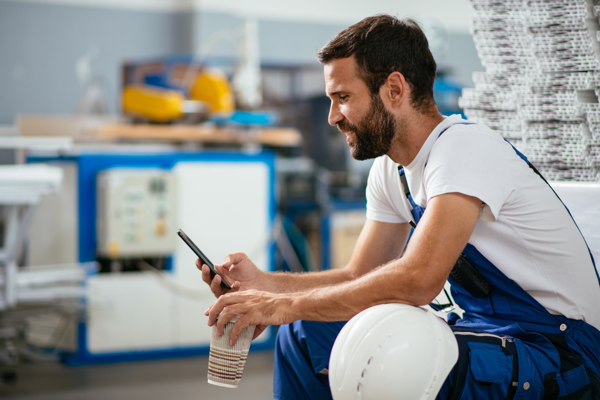 construction worker looking at his phone