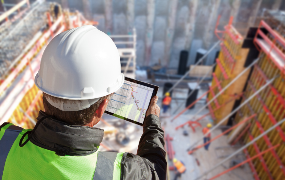 Construction worker working at a height and managing compliance on a tablet