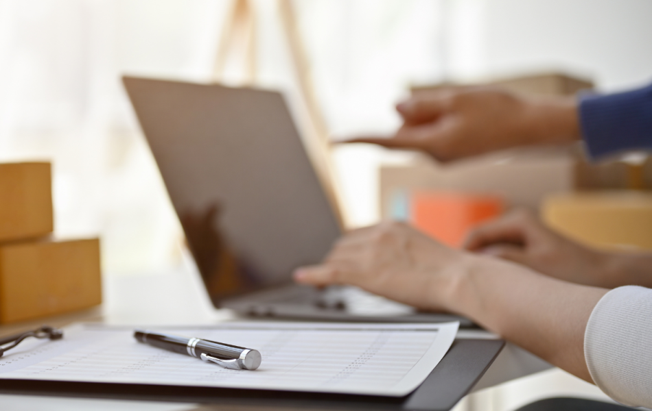 Construction admin on a laptop looking at compliance documents