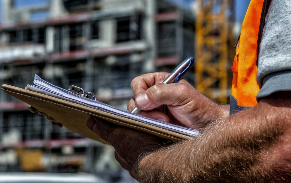 compliance officer checking paperwork on a construction site
