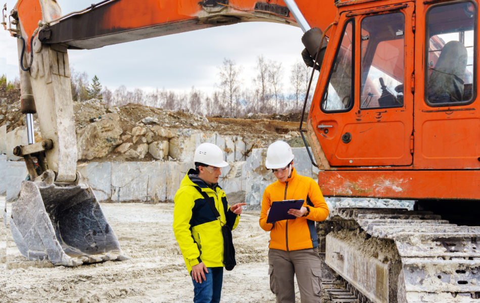 construction site with two tradies looking at paper work standing next to a truck